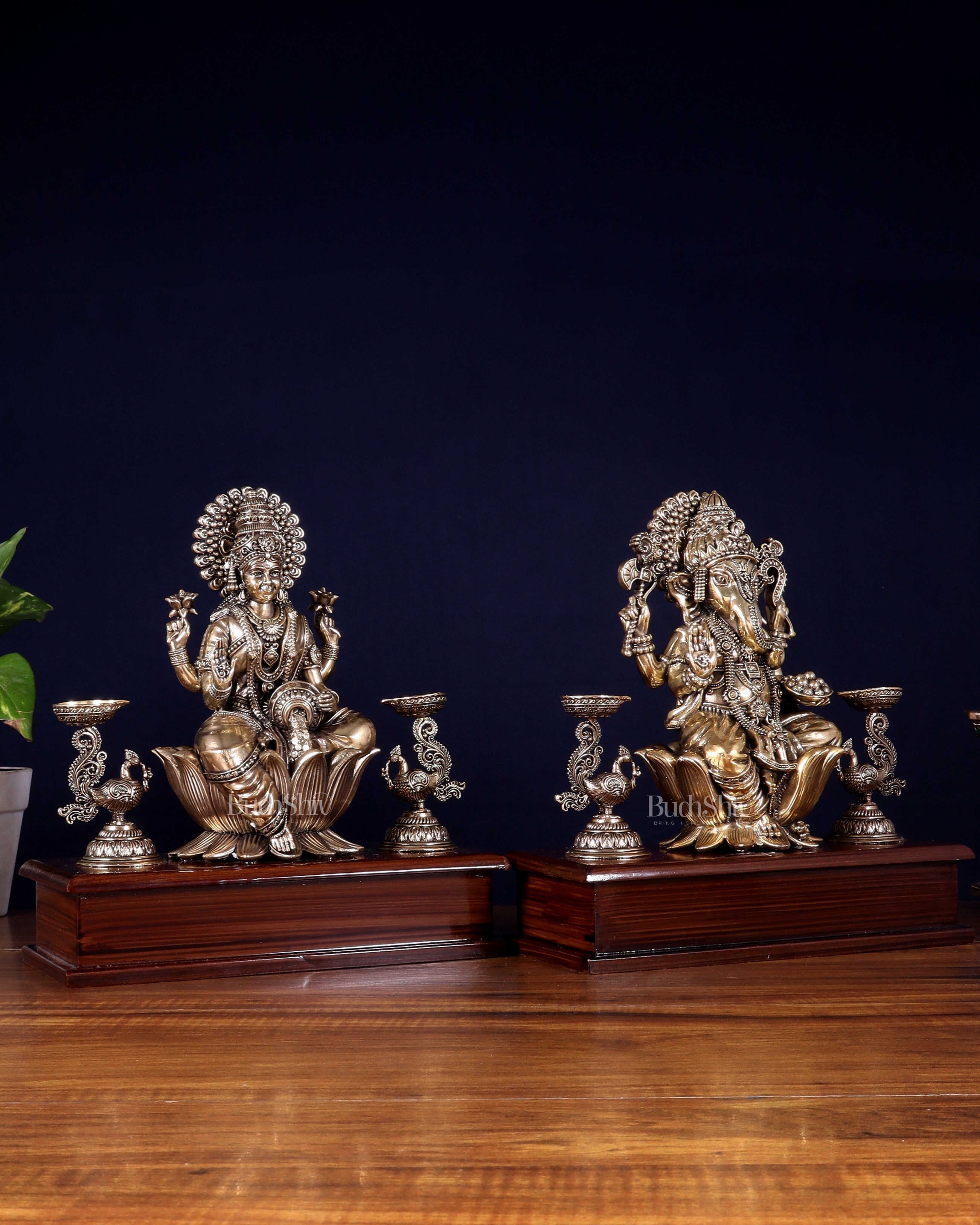 Brass Superfine Ganesh–Lakshmi Pair with Twin Peacock Lamps on Wooden Base – 9.5 Inch